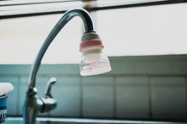 Water filtration system installed on kitchen faucet